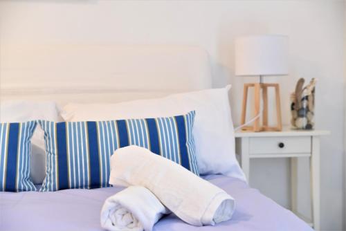 a towel sitting on top of a bed with pillows at PantaiaHomes - My Little Garden - Piscine - Vue panoramique in Tavernes