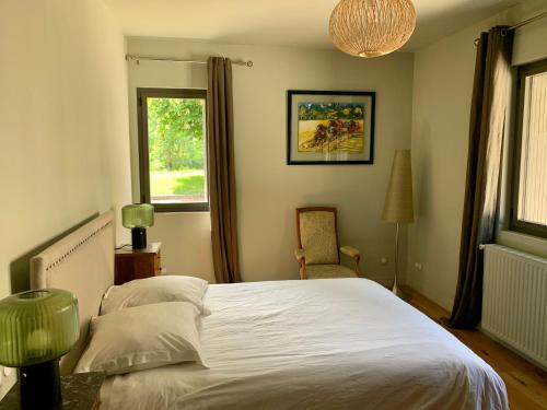 um quarto com uma cama branca e uma janela em DOMAINE DU PONT SALMOIS em Neuil