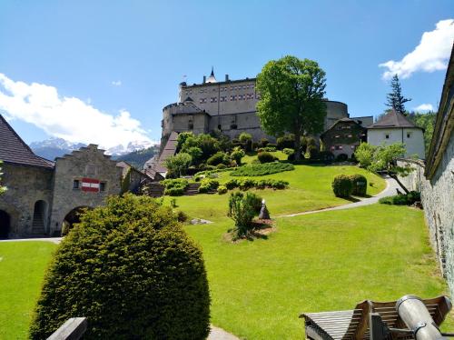 a castle on a hill with a green yard at M4 Appartements in Wagrain