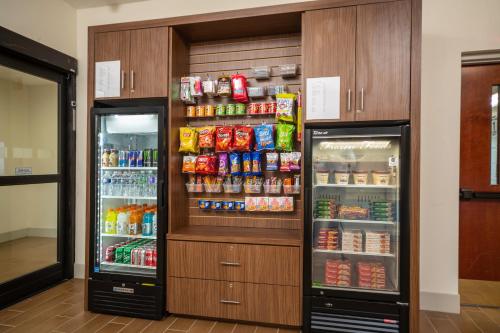 two refrigerators in a room with food and drinks at Holiday Inn Express Clayton Southeast Raleigh by IHG in Garner