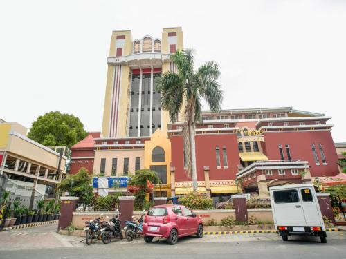 a red car parked in front of a building at Capital O 460 World Palace Hotel in Davao City