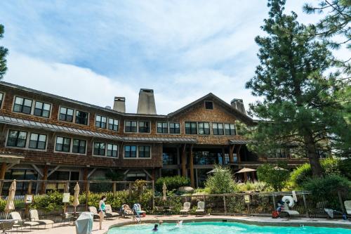 a large building with a pool in front of it at Sun Mountain Lodge in Winthrop