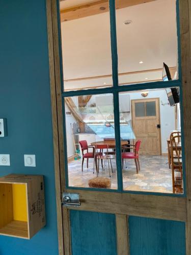a view of a dining room with a table and chairs at Au Cheval Blanc - appartements et chambres d'hôtes in Albertville