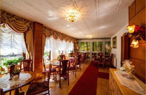 ein Esszimmer mit einem Tisch und Stühlen sowie ein Zimmer mit in der Unterkunft Pension Fuhrmann's Elb- Café in Bad Schandau