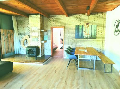 a living room with a table and a fireplace at Wellness Ferienwohnung Waldblick in Kellenhusen