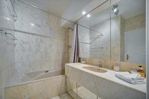 une salle de bain avec une baignoire, un lavabo et une douche dans l'établissement IMMOGROOM - Close beaches - Terrace with sea view - pool -AC, à Cannes