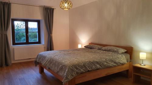 a bedroom with a bed and a window at HAUS WALD und SEE - WASSERBURG in Wasserburg