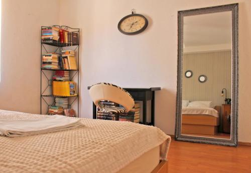a bedroom with a mirror and a chair and a bed at D&D in Drvenik