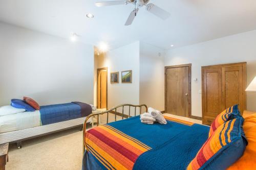 a bedroom with two beds and a ceiling fan at Mission Rock 2 in Ouray