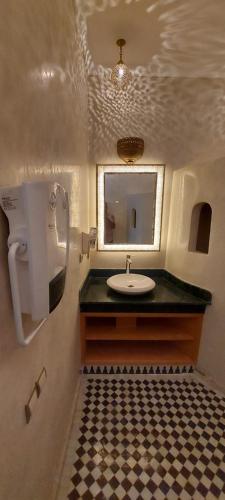 a bathroom with a sink and a mirror at Riad Barroko in Marrakech