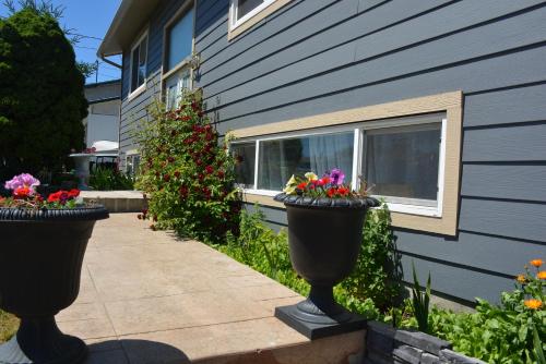 two planters with flowers in them next to a building at Aasra Home in Kelowna