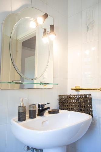 a bathroom with a white sink and a mirror at Τraditional fully detached villa on a luxurious hillock of Thessaloniki with its own garden also for family & wedding gatherings for 10 to 25 people only 15 minutes from airport in Thessaloniki