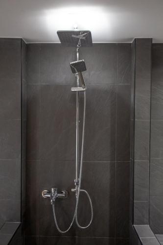 a shower with a shower head in a bathroom at Τraditional fully detached villa on a luxurious hillock of Thessaloniki with its own garden also for family & wedding gatherings for 10 to 25 people only 15 minutes from airport in Thessaloniki