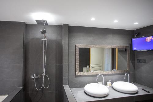 a bathroom with two sinks and a mirror and a shower at Τraditional fully detached villa on a luxurious hillock of Thessaloniki with its own garden also for family & wedding gatherings for 10 to 25 people only 15 minutes from airport in Thessaloniki
