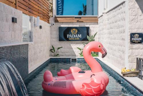 a pink inflatable flamingo in a pool at a hotel at Padam Hotel & SPA in Ulcinj