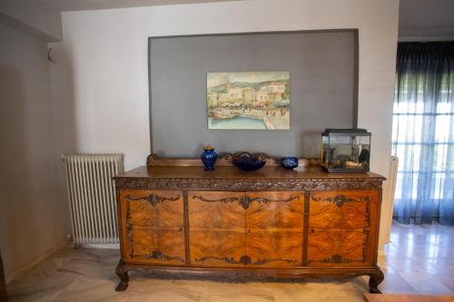 a wooden dresser with a fish tank on top of it at Τraditional fully detached villa on a luxurious hillock of Thessaloniki with its own garden also for family & wedding gatherings for 10 to 25 people only 15 minutes from airport in Thessaloniki