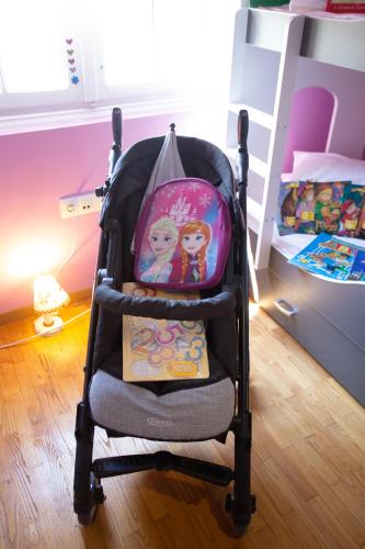 a baby stroller in a bedroom with a bunk bed at Τraditional fully detached villa on a luxurious hillock of Thessaloniki with its own garden also for family & wedding gatherings for 10 to 25 people only 15 minutes from airport in Thessaloniki
