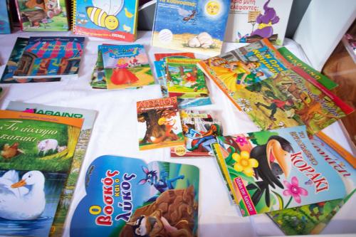 a table with childrens books on it at Τraditional fully detached villa on a luxurious hillock of Thessaloniki with its own garden also for family & wedding gatherings for 10 to 25 people only 15 minutes from airport in Thessaloniki