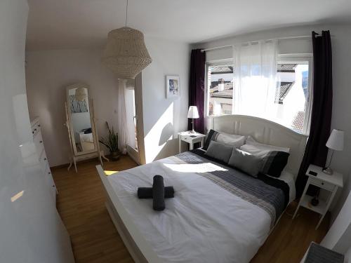 a bedroom with a large bed with a black cross on it at Casa San Tomas in Güéjar-Sierra