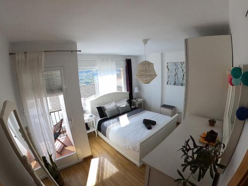 a small bedroom with a bed and a window at Casa San Tomas in Güéjar-Sierra