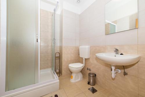 a bathroom with a sink and a toilet and a shower at Orange Tree Garden in Trogir