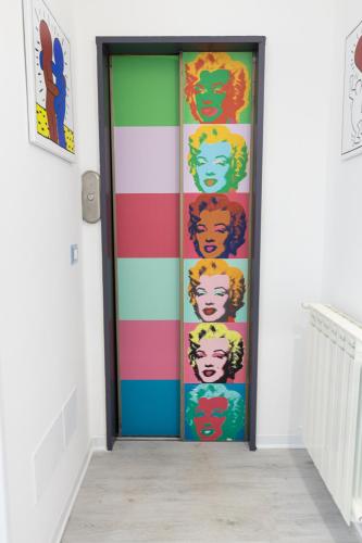a colorful door with a colorful face painted on it at Valmontone Travel Rooms in Valmontone