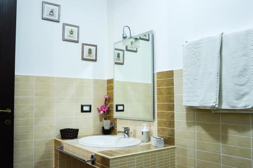 a bathroom with a sink and a mirror at A due passi dal mare in Capo dʼOrlando