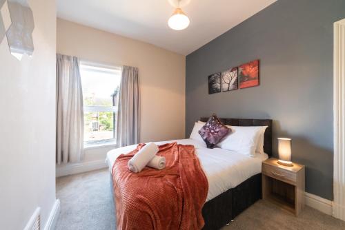 1 dormitorio con cama y ventana en 3 Bedroom-5 Beds Newland Ave King's Palace Leisure-Contractor-Heart of Hull Amenities en Hull