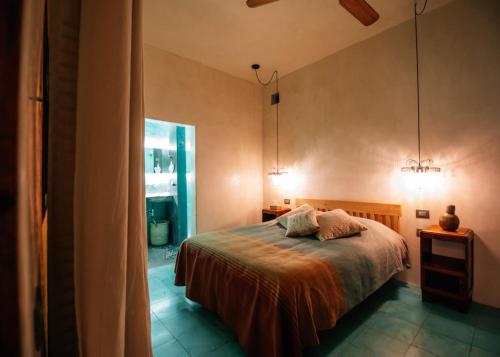 a bedroom with a bed with two pillows on it at Boulenc Bed and Bread in Oaxaca City