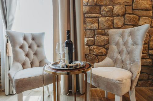 two chairs and a table with a bottle and a wine glass at Four Elements - Fire & Air in Split