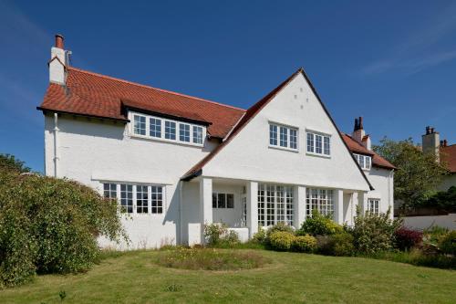a white house with a red roof at Troon Arts & Crafts Period Home Golf Beach in Troon