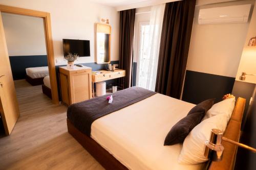 a hotel room with a bed and a desk and a mirror at Urla 1867 Hotel in Urla