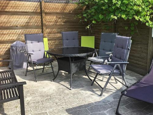 a group of chairs and a table and a table and chairs at 4 person holiday home in Hemmet in Hemmet