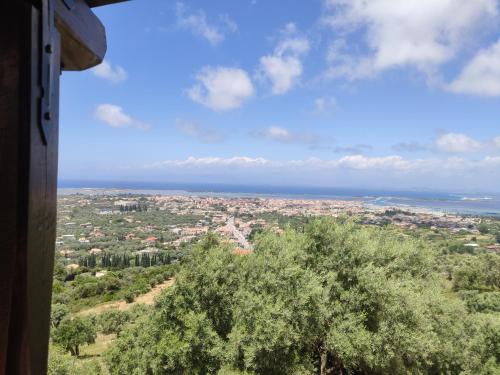 a view of a city with a tree and the ocean at Irida in Lefkada Town