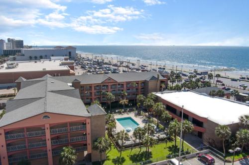 an aerial view of a resort and the ocean at Beachfront Palms Hotel Galveston in Galveston