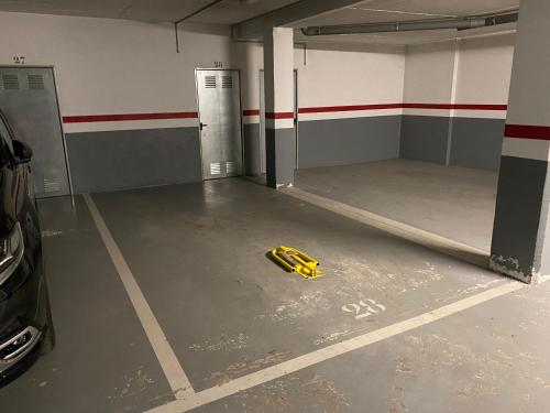 an empty parking garage with a bunch of yellow gloves at Residencial Sol i Ski 24 4p Ransol El Tarter Zona Grandvalira in Sant Pere