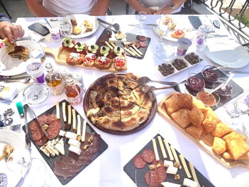 a table with a bunch of different types of food at Padam Hotel & SPA in Ulcinj