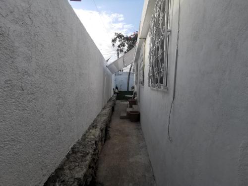 an alley way between two white buildings at Villa Tulipan (Downtown of Cancun) in Cancún