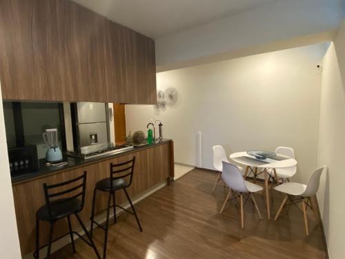 a kitchen with a table and chairs in a room at Del Parque Suites in Mexico City