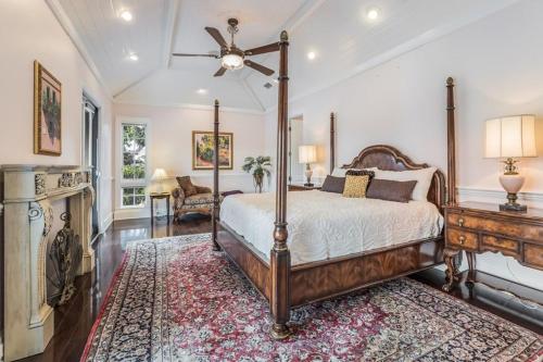 a bedroom with a canopy bed and a fireplace at Sarasota Luxury Estate in Sarasota