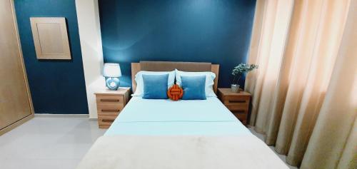 a bedroom with a large bed with blue walls at kelly's House Plateau City Center in Praia