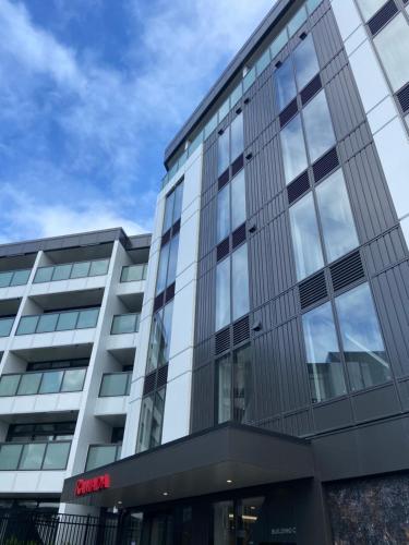 an office building with a lot of glass windows at Ramada by Wyndham Newmarket Auckland in Auckland