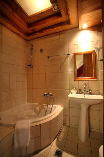 a bathroom with a tub and a sink at Palazzo di Pietro in Chania Town