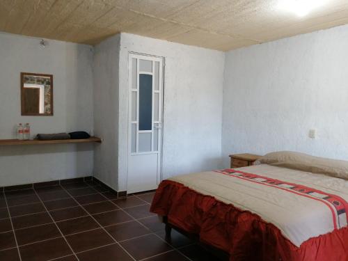 A bed or beds in a room at Axolokalko Teotihuacan