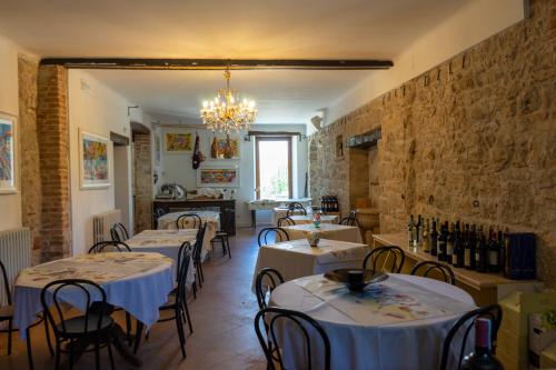 a restaurant with tables and chairs and a chandelier at Dimora BOUQUET & GOURMET in Ascoli Piceno