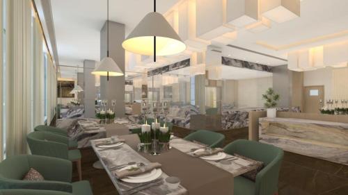 a dining room with tables and green chairs at Radisson Hotel Bareilly Airport in Bareilly