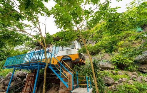 a bus is parked on top of a tree at An's Eco Garden Resort in Ninh Binh