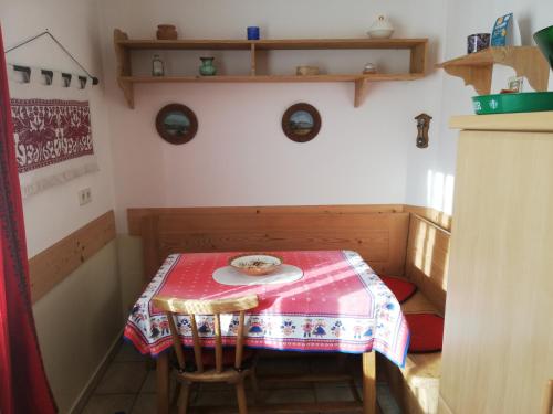 a small table with a red table cloth on it at Haus Friedburg in Velden am Wörthersee