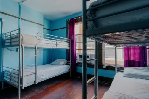 a room with two bunk beds and a window at Lucky D's Youth and Traveler's Hostel in San Diego