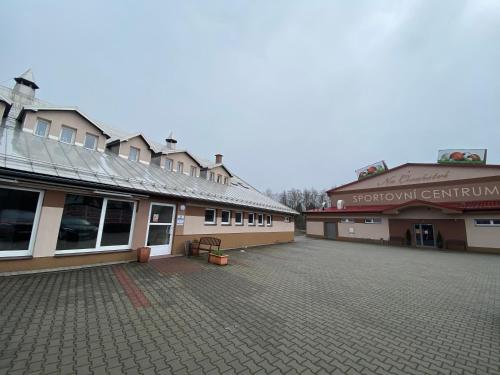 an empty parking lot in front of two buildings at Penzion Na Císařství in Horní Suchá